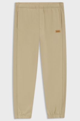 Cotton-terry tracksuit bottoms with logo badge, Beige