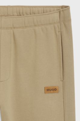 Cotton-terry tracksuit bottoms with logo badge, Beige