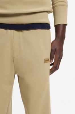 Cotton-terry tracksuit bottoms with logo badge, Beige