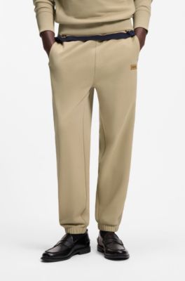 Cotton-terry tracksuit bottoms with logo badge, Beige