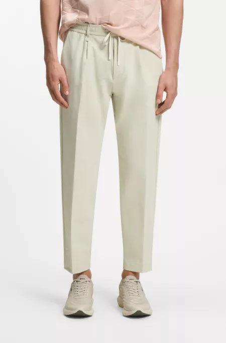 Pantalones tapered fit activos de tejido elástico repelente al agua