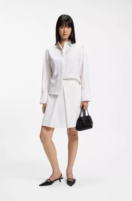 Pleated A-line mini skirt in stretch fabric