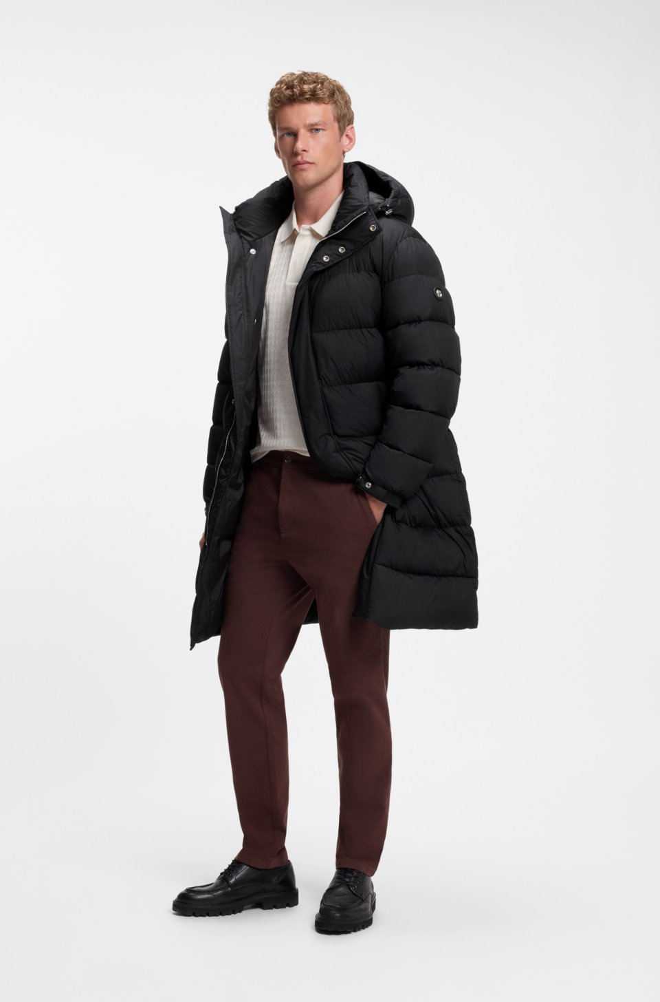 Long-length water-repellent puffer jacket with concealed closure