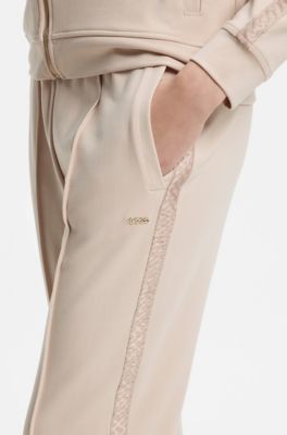 Trainingsbroek van stretchmodal met monogramband, Lichtbeige