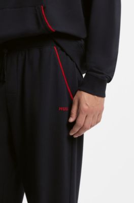 Cotton-blend cuffed tracksuit bottoms with logo piping, Black