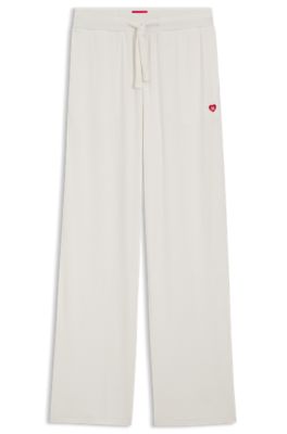 Stretch-modal tracksuit bottoms with heart logo, Natural