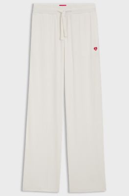 Stretch-modal tracksuit bottoms with heart logo, Natural