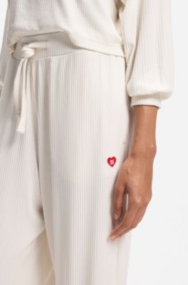 Stretch-modal tracksuit bottoms with heart logo, Natural