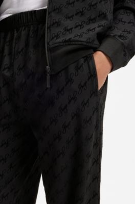 Relaxed-fit tracksuit bottoms with flocked-logo print, Black