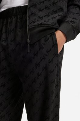 Relaxed-fit tracksuit bottoms with flocked-logo print 2