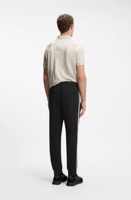 Triangle-jacquard tracksuit bottoms with rubberised logo