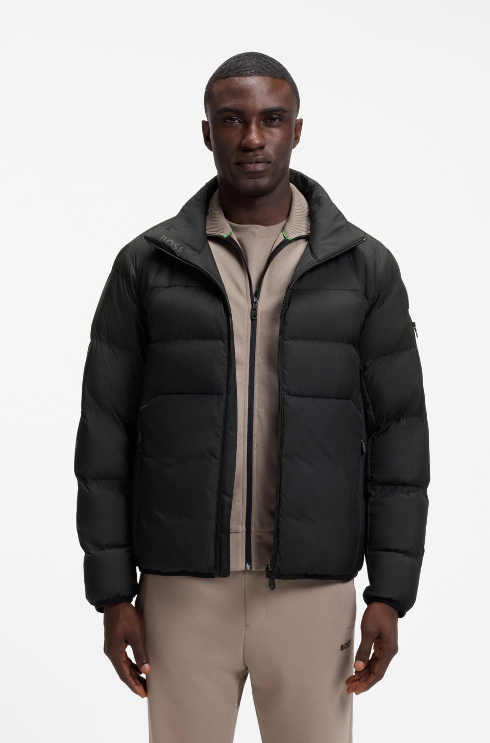 Water-repellent puffer jacket with zipped sleeve pocket