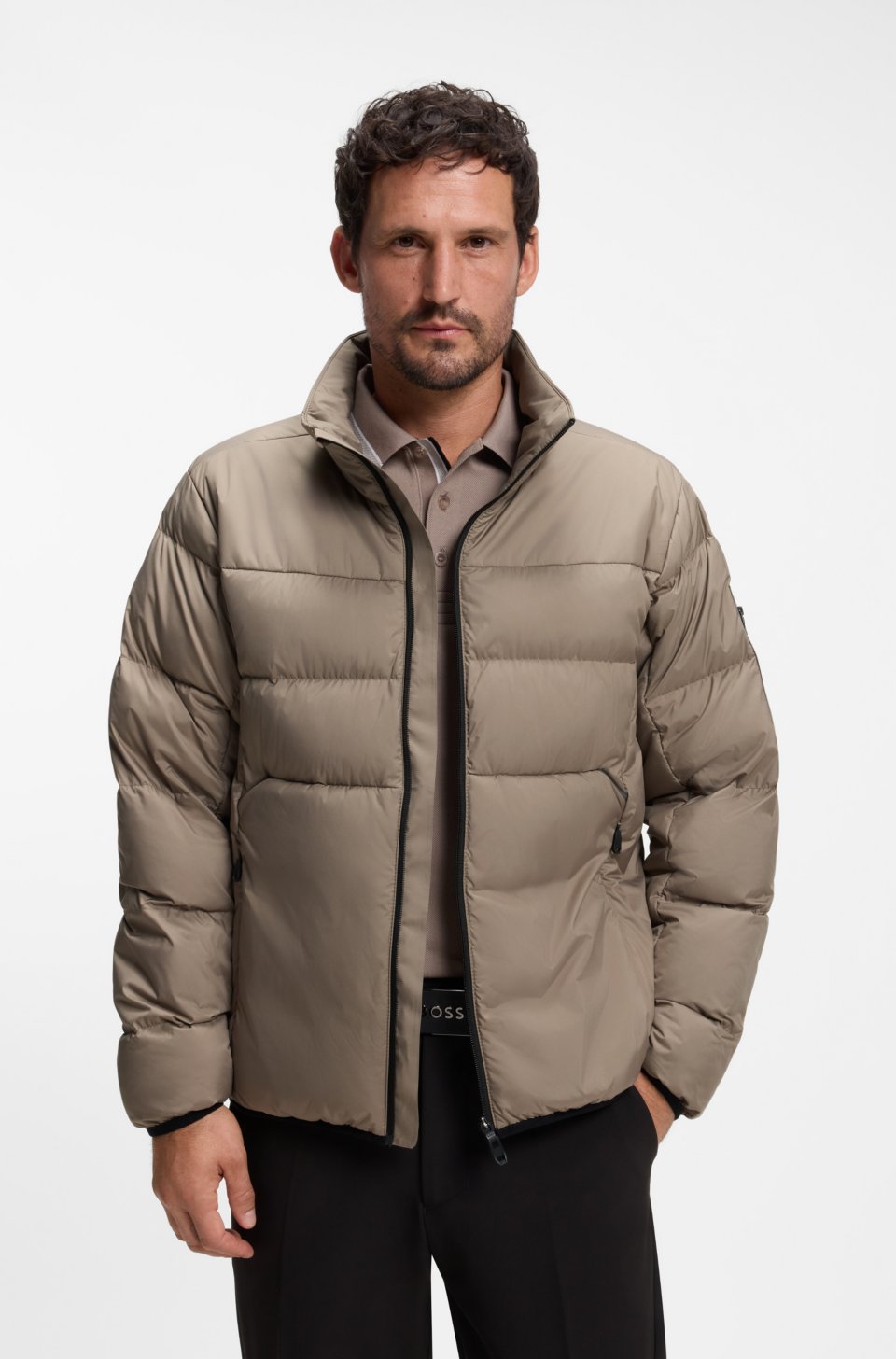 Water-repellent puffer jacket with zipped sleeve pocket