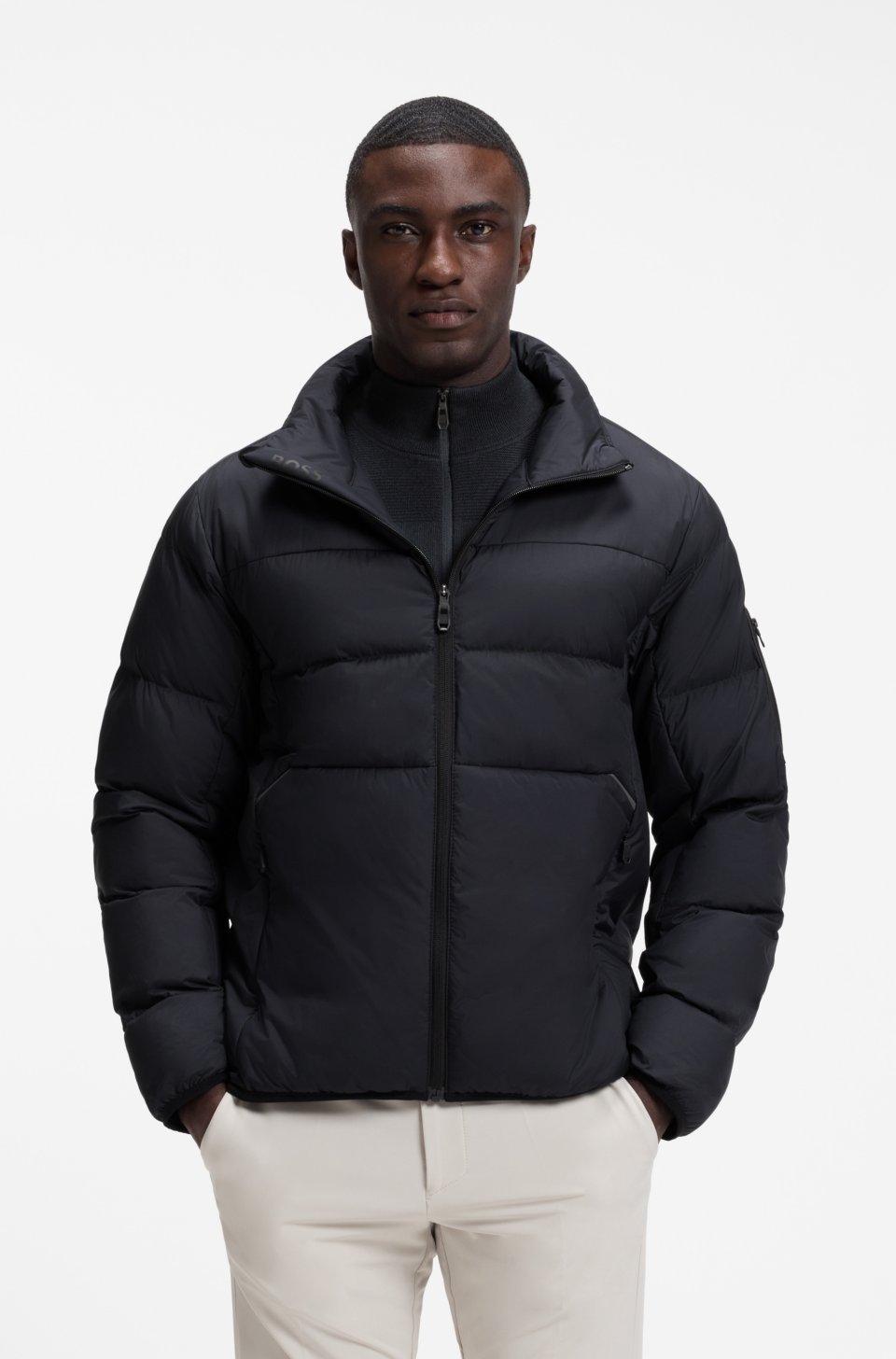 Water-repellent puffer jacket with zipped sleeve pocket