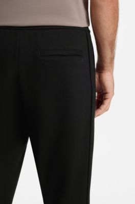 Regular-fit tracksuit bottoms with four-way stretch, Black