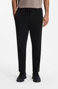 Regular-fit tracksuit bottoms with four-way stretch, Black