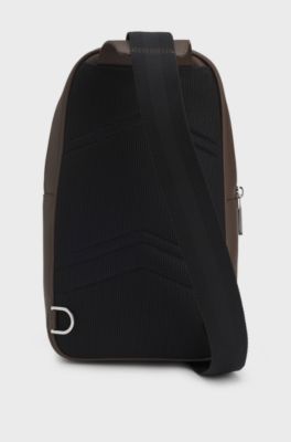Sleek faux-leather backpack with metal branding, Dark Brown