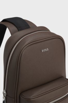 Sleek faux-leather backpack with metal branding, Dark Brown