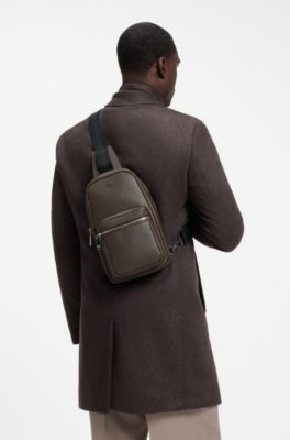 Sleek faux-leather backpack with metal branding, Dark Brown