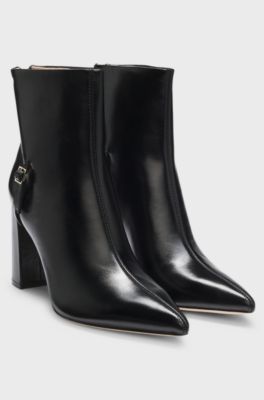 Pointed-toe boots in glossy leather with buckle detail, Black