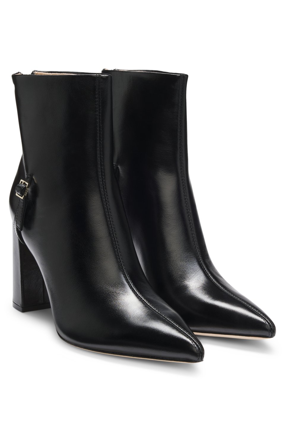 Pointed-toe boots in glossy leather with buckle detail