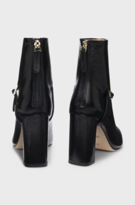 Pointed-toe boots in glossy leather with buckle detail, Black
