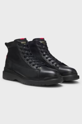 Half boots in leather with textured panels, Black
