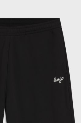 Relaxed-fit tracksuit bottoms in cotton with script logo, Black