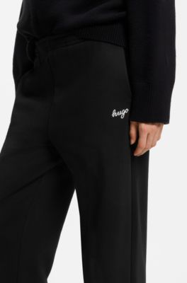 Relaxed-fit tracksuit bottoms in cotton with script logo, Black