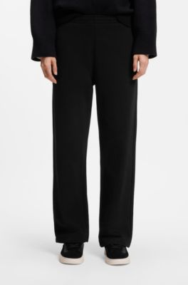 Pantalones de ch&aacute;ndal relaxed fit de algod&oacute;n con logo manuscrito, Negro