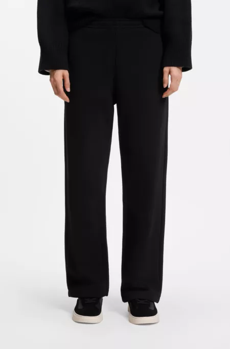 Relaxed-fit tracksuit bottoms in cotton with script logo