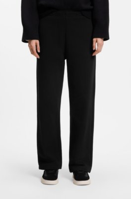 Relaxed-fit tracksuit bottoms in cotton with script logo