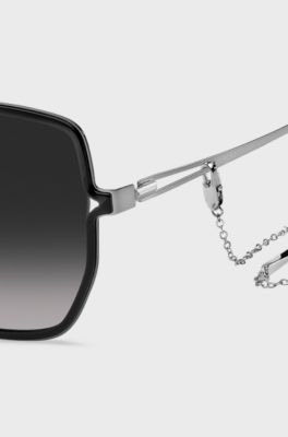 Black-frame sunglasses with forked temples and branded chain, Black