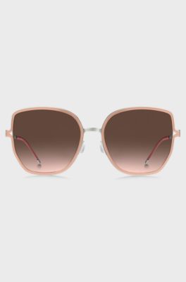 Nude-frame sunglasses with forked temples and branded chain, light pink