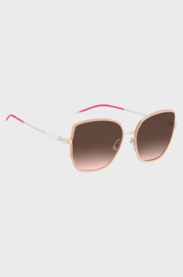 Nude-frame sunglasses with forked temples and branded chain, light pink