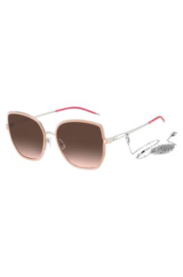Nude-frame sunglasses with forked temples and branded chain, light pink