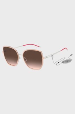 Nude-frame sunglasses with forked temples and branded chain, light pink