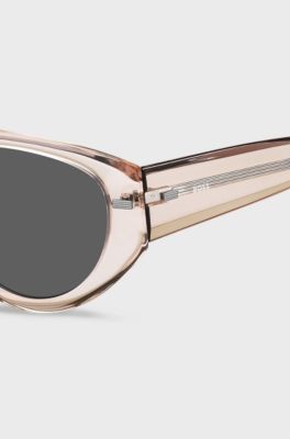 Translucent pink bio-acetate sunglasses with patterned rivets, light pink