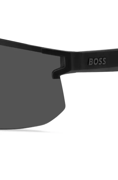 Black mask-style sunglasses with branded temples and bridge