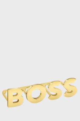 Light-golden-plated knuckle ring with logo letters, Gold tone