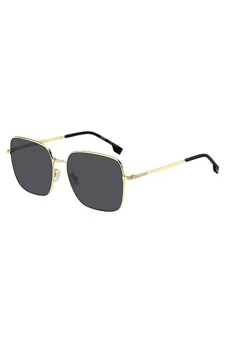 Goldfarbene Sonnenbrille mit charakteristischen Metalldetails, Gold