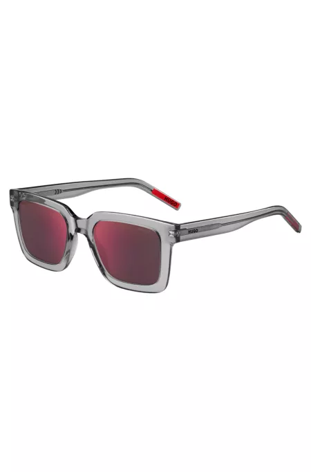 Transparent-acetate sunglasses with red lenses