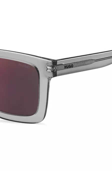 Transparent-acetate sunglasses with red lenses