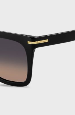 Sonnenbrille aus schwarzem Acetat mit goldfarbenen Metalldetails, Schwarz