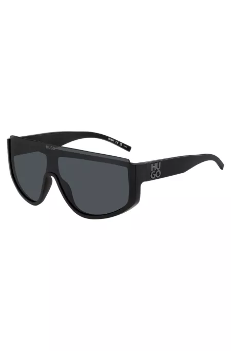 Mask-style sunglasses in black with stacked logo
