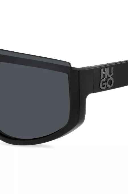 Mask-style sunglasses in black with stacked logo