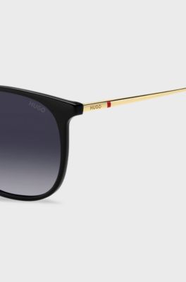 Schwarze Sonnenbrille mit goldfarbenen B&uuml;geln, Schwarz