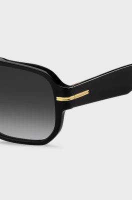 Black-acetate sunglasses with gold-tone details , Black