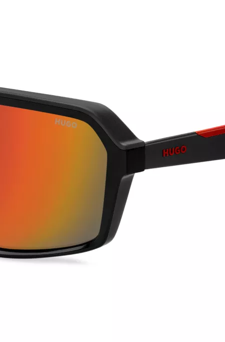 Mask-style sunglasses with red shaded lenses