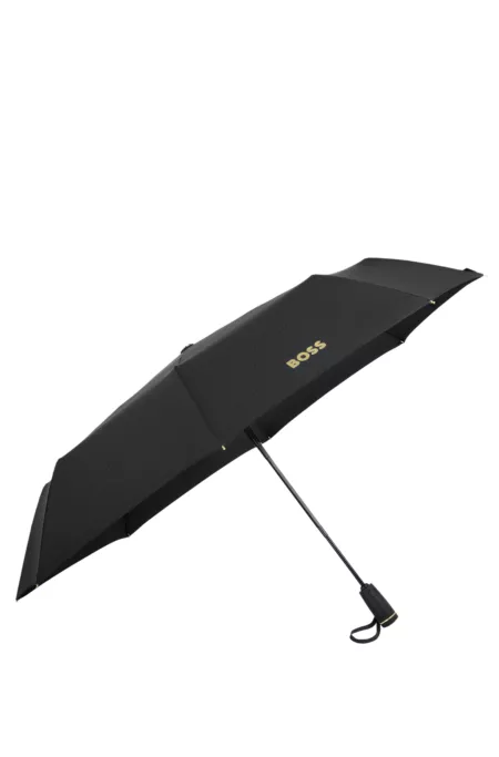 Monogram-canopy pocket umbrella in black and gold